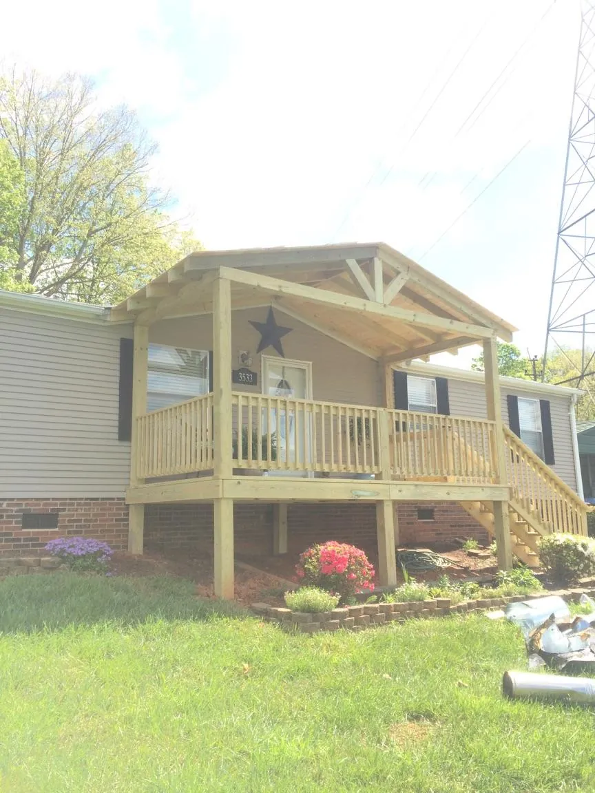 New gabled porch roof and deck railing added to a ranch home in Axtell